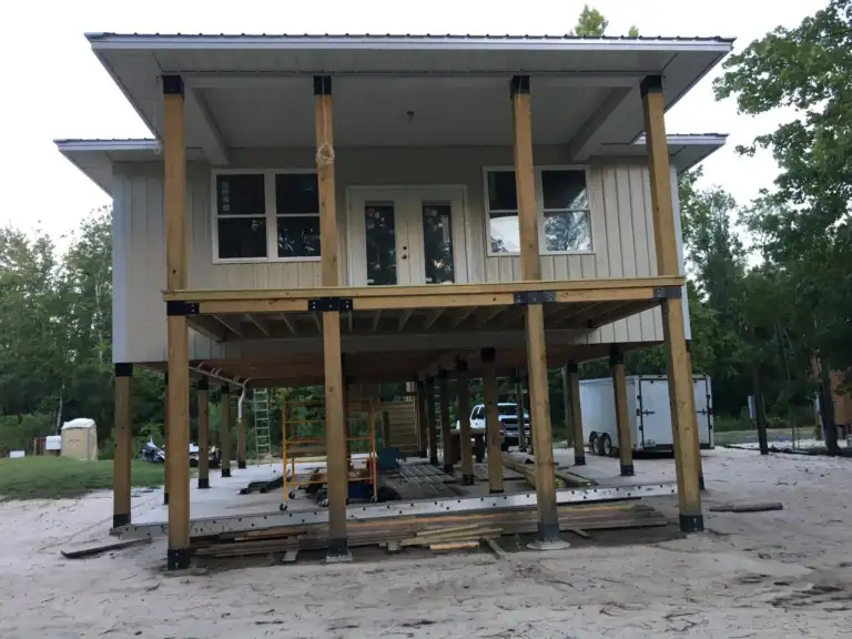 Front of a raised home on wood posts anchored with the Ty-Rite system