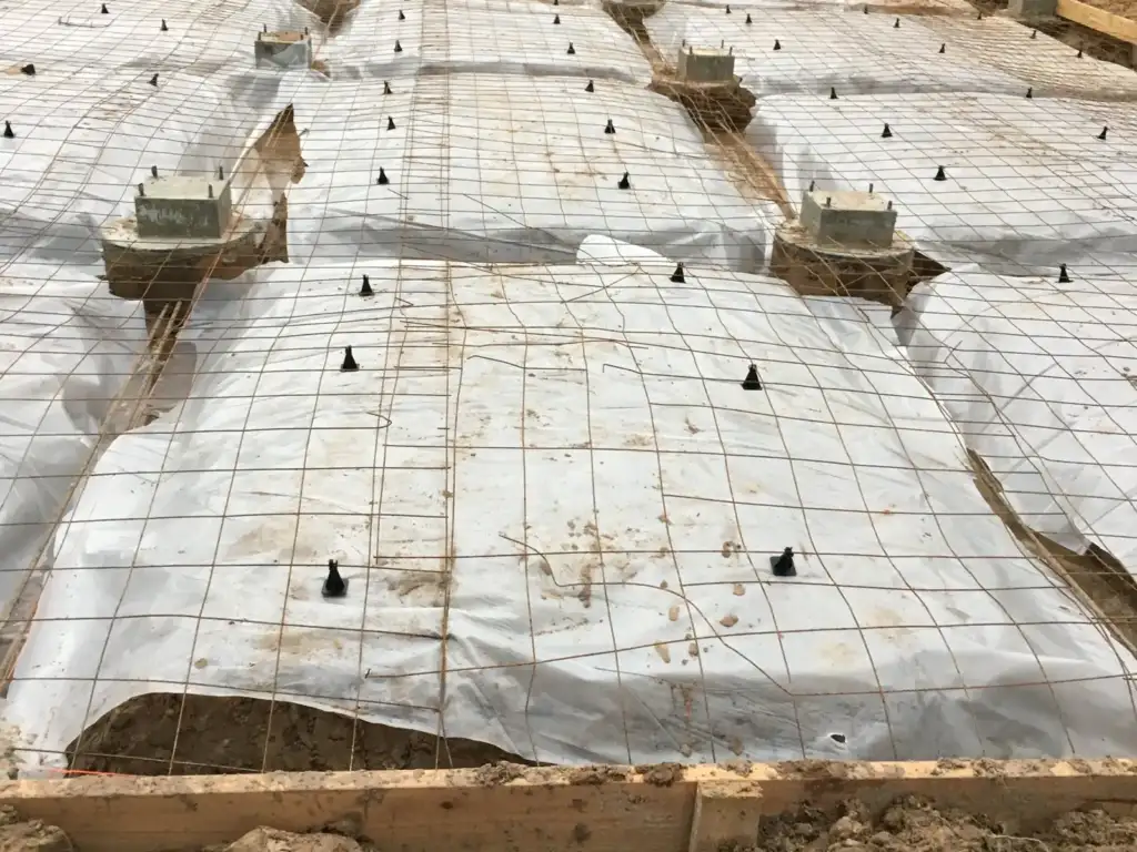 Footing rebar grid with Ty-Rite anchors laid out before the pour