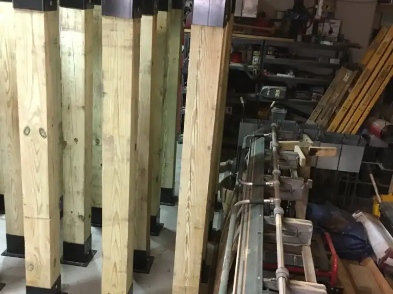 Wood posts fitted with Ty-Rite anchors lined up in the shop